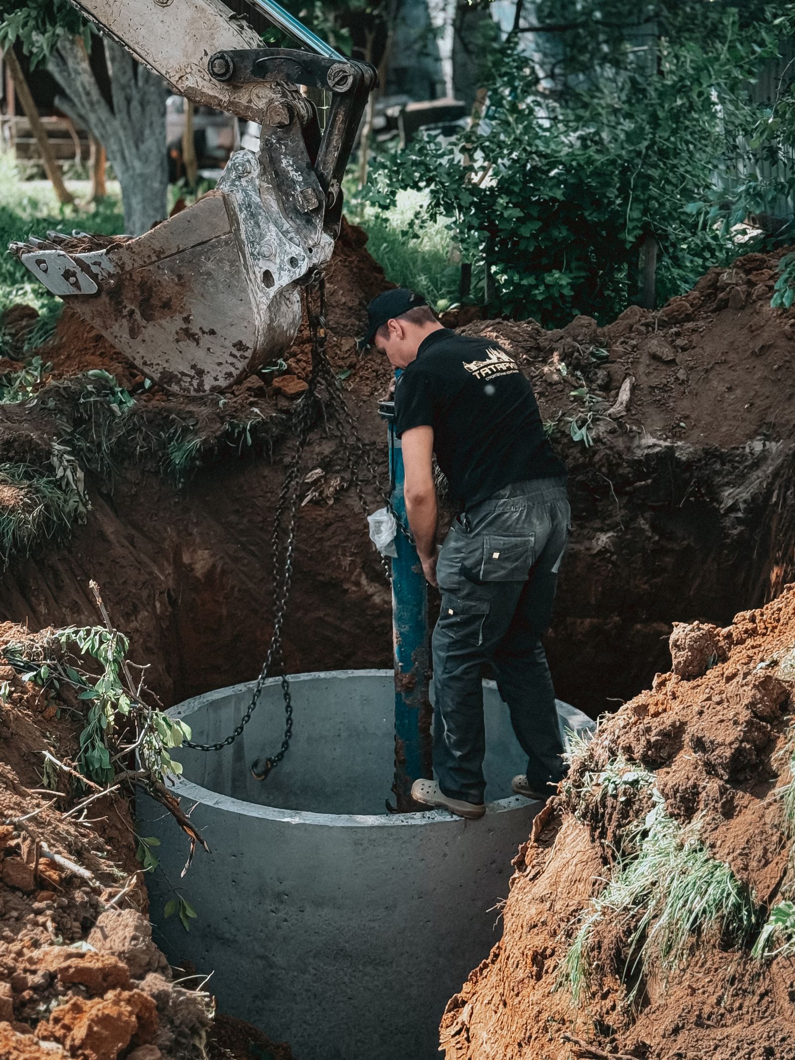 Septic tank being installed in an excavated pit